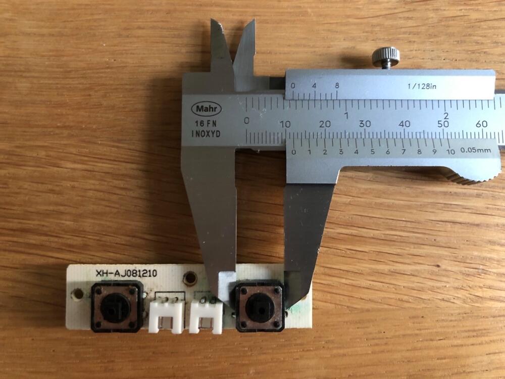 Button PCB with caliper to meassure the switches